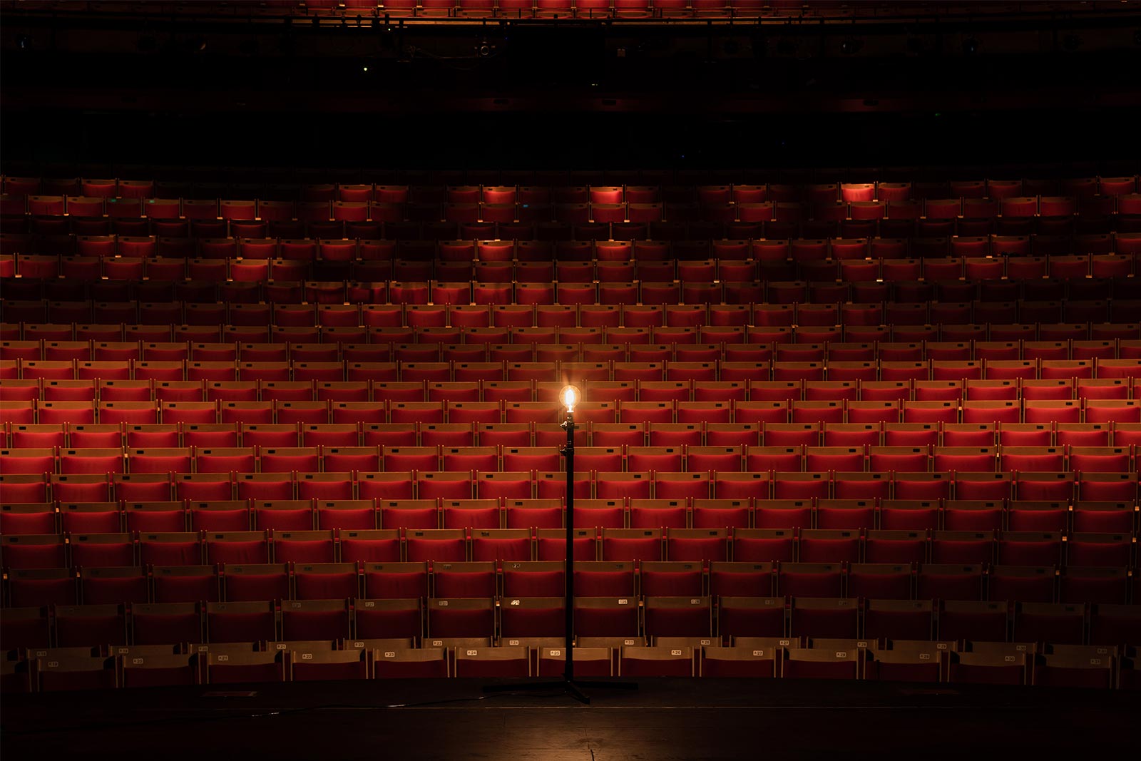 Image of a ghostlight in an empty theatre.